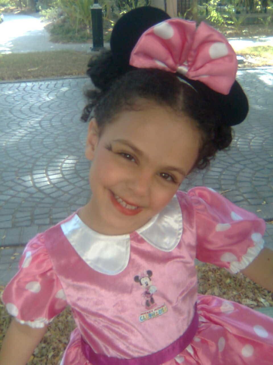 Off-duty as Minnie Mouse. Sources describe the smile as 'the same one.'
